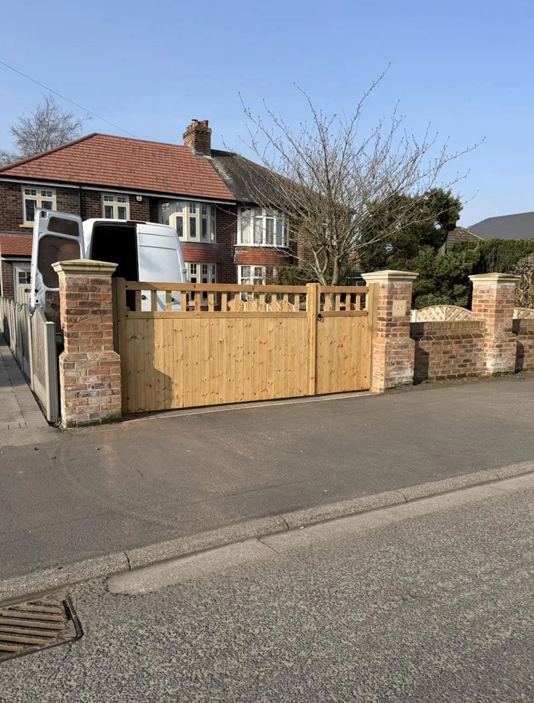 Wood double-swing driveway gate installed in Naperville, IL